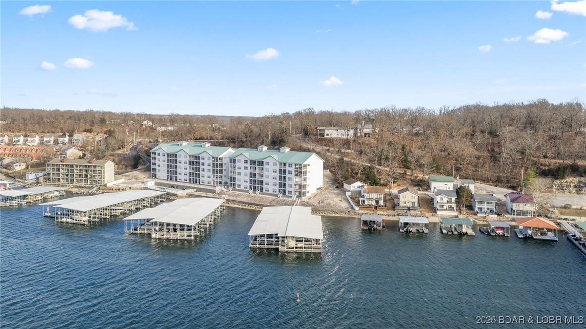 Experience lakefront luxury in this fully furnished 4 bed, 4 bath condo in the heart of Lake of the Ozarks. With stunning panoramic water views  and spacious open-concept living, this two level unit is perfect for full-time living or weekend escapes at Lake of the Ozarks! Two bedrooms are en-suites, offering comfort and privacy for family and guests. Step onto the private balcony to take in breathtaking sunsets over the lake—your front-row seat to serenity. The bright living and dining areas flow effortlessly, ideal for relaxing or entertaining. This unit includes a 14x36 slip (3-19), a 12 x36 slip (3-20)and 2  exterior PWC spaces! Located minutes from top dining, shopping, and entertainment, on the Bagnell Dam Strip - you'll have the best of lake lifestyle at your fingertips. Whether you’re boating all day or unwinding at sunset, this condo offers the ultimate blend of adventure and tranquility. Don’t miss your chance to own this rare gem—schedule your private showing today!