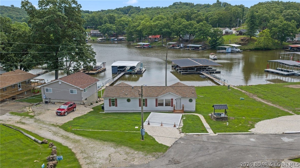 Lakefront home for under $320,000 at Lake of the Ozarks? Experience this beautifully renovated 3- bedroom , 2-bath home located at the 8 MM in Buck Creek Cove. Featuring desirable main-level living, this home offers stunning lake views and an inviting layout perfect for relaxing or entertaining. A standout feature is the included 10 X 24 boat slip in the community dock, providing easy access to the lake and endless days on the water. The low monthly HOA fee covers lawn care, water, sewer, and dock maintenance making ownership easy and affordable. The community is also developing a golf cart parking area and path, making it even easier to enjoy the neighborhood and waterfront amenities. Whether you are looking to expand your investment portfolio with a property well-suited for nightly rentals or searching for the perfect second-home retreat, this lake-view property checks all the boxes. Don't miss your chance to own a place by the Lake. Call for a private showing today!