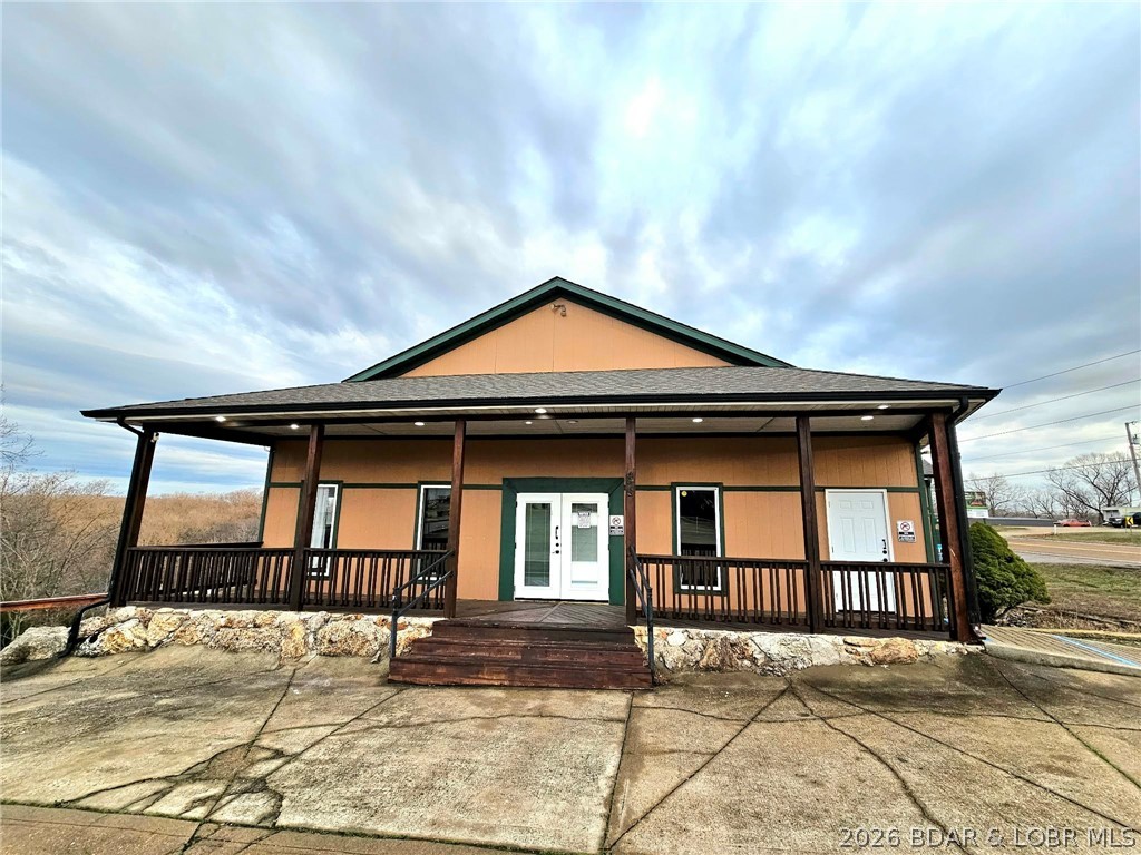 MOTIVATED SELLER/OWNER FINANCING with 20% down and 5% interest! If you're exploring commercial opportunities at the Lake of the Ozarks, this is one you won’t want to miss. This prime highway frontage property offers exceptional visibility and steady high-traffic exposure in the heart of the lake area.  Previously operated as a bar and grill, this turnkey property is ready for your next venture—whether that’s a restaurant, bar, entertainment venue, retail space, or something entirely new. The flexible layout makes it easy to bring your vision to life.  Positioned to capture both local and tourist traffic, this location provides built-in exposure and strong potential for success. Two on-site 2 bed 1 bath apartments, perfect for generating rental income or providing owner/employee housing. One is setup for Airbnb and part of this package. Located less than 10 min. from Bagnell Dam and just 15 min. to Osage Beach you’ll be right in the center of it all. The 1.92-acre lot offers additional space for expansion or future development. Whether you're launching a new business or expanding your portfolio, this is an affordable opportunity to establish yourself at the Lake of the Ozarks.