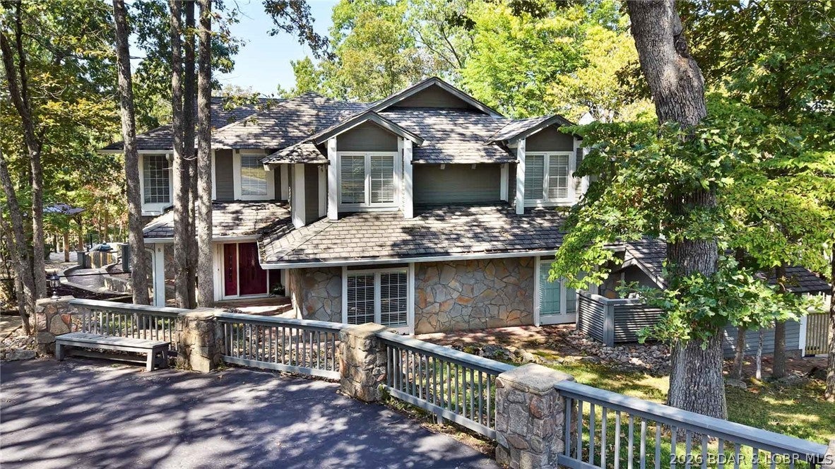 Welcome to this exceptional custom-built residence nestled in the gated Oak Creek Subdivision, surrounded by The Oaks Golf Course. Designed with architectural details rarely found in new construction. The home sits on a private interior lake with a park-like setting along the 18th tee box. Enjoy breathtaking grounds featuring walking paths through wooded areas, a firepit near the water, irrigation, and an underground pet fence. The deep, private lake is stocked with spoonbill, carp, catfish, & more and is home to turtles, herons, eagles, and abundant wildlife. (Catch & Release fishing allowed - residents only) 4 bedrooms w/en-suites + flexible 5th bedroom/hobby room, 5 full baths. Gourmet kitchen with custom cabinetry, granite, Viking gas range & oven, oversized fridge/freezer, wine fridge, ice maker, 3 sinks, trash compactor, large butler’s pantry. Library/office with knotty pine and coffered ceilings. Extra Large laundry room near bedrooms.
Two new patios (1 covered) + private deck off primary. 2-car garage includes one heated/cooled bay + golf cart garage. 2 driveways for extra parking. Convenient to Margaritaville, fine dining, hospital & shopping.