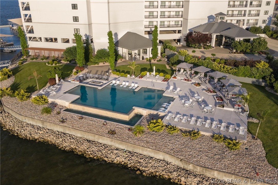 Welcome to Cypress at the Lake, one of Lake of the Ozarks' most prestigious condominium communities. Opportunities to own in this gated, no-nightly-rental development at this price are rare, and this beautifully maintained 3-br, 3-bath residence offers the perfect chance to experience resort-style lake living at an exceptional value. Built in 2018, this 1,692 sq. ft. condo showcases the modern design, quality construction, & upscale finishes that have made Cypress at the Lake the premier condo destination. Freshly painted, professionally cleaned, this unit is ready for you to start enjoying summer immediately. The spacious floor plan opens to an incredible tiled, covered deck where you'll enjoy breathtaking lake views & outdoor living at its finest. The amenities here are simply unmatched. Relax at the stunning resort-style pool complete with private cabanas, gather with friends at the indoor/outdoor wine bar, utilize the Green Egg grilling stations, & enjoy conveniences including covered parking, elevators, fitness center, commercial ice maker, and beautiful landscaping. Elevators provide easy access to the waterfront and your included 12x32 boat slip, making lake days effortless.