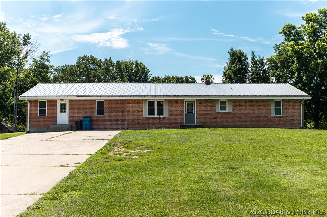 Nestled in a charming community, this spacious home offers the perfect blend of small-town living & versatile living space. Located just 45 minutes from Jefferson City & the Lake of the Ozarks, you'll enjoy a peaceful setting without sacrificing accessibility. The main level features 3 bedrooms, including a primary suite with its own full bathroom, along with a second full bath for family & guests. The kitchen serves as the heart of the home & comes with all appliances, including the washer & dryer, making your move easier. Downstairs, you'll discover additional living space designed to adapt to your needs. A 2nd family room creates the perfect spot for movie nights or relaxing. The large recreation room, previously used as a daycare, offers endless possibilities & could easily become a home gym, hobby area, mother-in-law suite, or even be reconfigured to add additional bedrooms. A convenient half bath & wet bar make this level ideal for entertaining or multi-generational living. Storage will never be an issue thanks to the oversized storage room, perfect for a workshop or canning room. Schedule your private showing today and see all the possibilities this unique home has to offer!