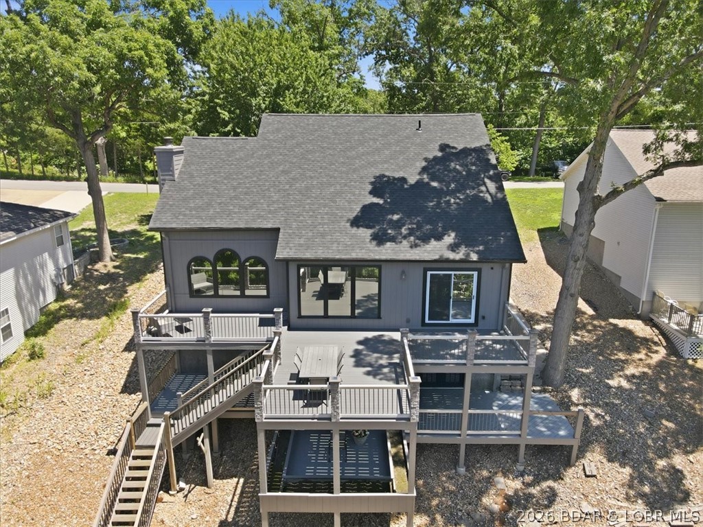 Welcome to lakefront living in one of the most sought-after locations at the Lake of the Ozarks! Conveniently situated just off Bagnell Dam Blvd, this spacious waterfront home offers city water, city sewer, paved roads, and easy access to shopping, dining, and entertainment. Designed with comfort and functionality in mind, the home features 4 bedrooms, including a versatile bonus room that can serve as a 5th bedroom, media room, or office. The main-level living floor plan includes a generous primary suite, formal dining area, cozy kitchen with a breakfast nook, and an impressive great room highlighted by vaulted ceilings and expansive windows that showcase lake views. Multiple decks provide the perfect setting for relaxing or entertaining outdoors. A level driveway leads to the attached 2-car garage, while the massive walk-in crawl space offers approximately 1,500 square feet of additional storage or potential future living space. Outside, enjoy a 1-well dock and a gently sloping lakeside yard with plenty of room for a fire pit, outdoor seating, or your own waterfront oasis. This property is ready for you to start making Lake of the Ozarks memories this summer! DON'T MISS IT!!!