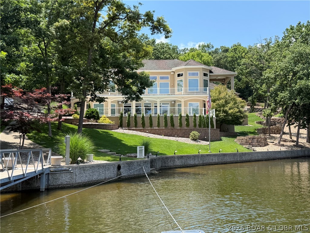 One of a Kind Property Located in the Village of Shawnee Bend. Stunning Lot with Gated Entry, Beautiful Landscaping, Golf Cart Path to the Dock, 209 ft of lakefront, Perfect Cove Location, TONS of parking PLUS 3 car attached garage, gentle Heated Driveway and an AMAZING home too! You will be impressed as soon as you walk in the door.... Soaring Ceilings with custom lighting, Gourmet Kitchen w/ custom Auburn Cherry Cabinets, Granite Countertops, Radiant Heat 18" Travertine Marble Floors throughout home, Spacious Primary Suite with luxurious bathroom (jetted Tub, Oversized Walk in tiled shower & Huge walk in closet), 4 Guest Bedrooms on Lower Level, Lower Level Famliy Room with Wetbar & screen projection theater & Sound System, Covered Deck and Open Deck on Main level PLUS covered Patio & Open Patio from lower level... you walk straight out to the pool area! Pool is Heated too.  The Concrete Dock was custom Built and allows plenty of room to entertain or just relax on the dock. A nice lakeside stone patio with firepit allows for year round enjoyment! Home has a state of the art electronics system and so much more. A lot like this is hard to find in the Villages!
