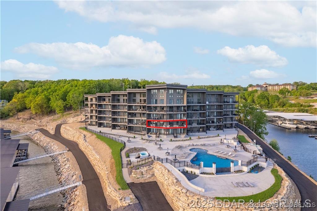 UPSCALE LAKEFRONT CONDO! Discover style with this 2024-built luxury condo located in one of the most sought-after locations, Horseshoe Bend! Offering panoramic lake views of the 13mm & a thoughtfully designed 1814 sqft floor plan, this home is ideal for those who want views, comfort & quality without compromise. Step inside to open space with soaring high ceilings, custom craftsmanship including-custom cabinets, custom closets, custom lighting, custom electric blinds, & custom flooring for a seamless, premier look. The open-concept living area flows effortlessly to a spacious lakeside deck, perfect for entertaining or enjoying stunning sunsets. The 4 bedrooms is designed for comfort, while 4 bathrooms ensures convenience. Accessibility is a top priority, enjoy zero-step entry, ADA compliance, & elevator access—making it true easy lake living. This property includes a 16x48 boat slip(A2), a garage, trailer parking, & boat ramp for the ultimate lake experience. Lounge under the cabanas by the infinity pool, or hang out by the lakeside firepit, this unit truly offers it all! Make it a full time lake escape, weekend retreat, or revenue opportunity from nightly rentals.