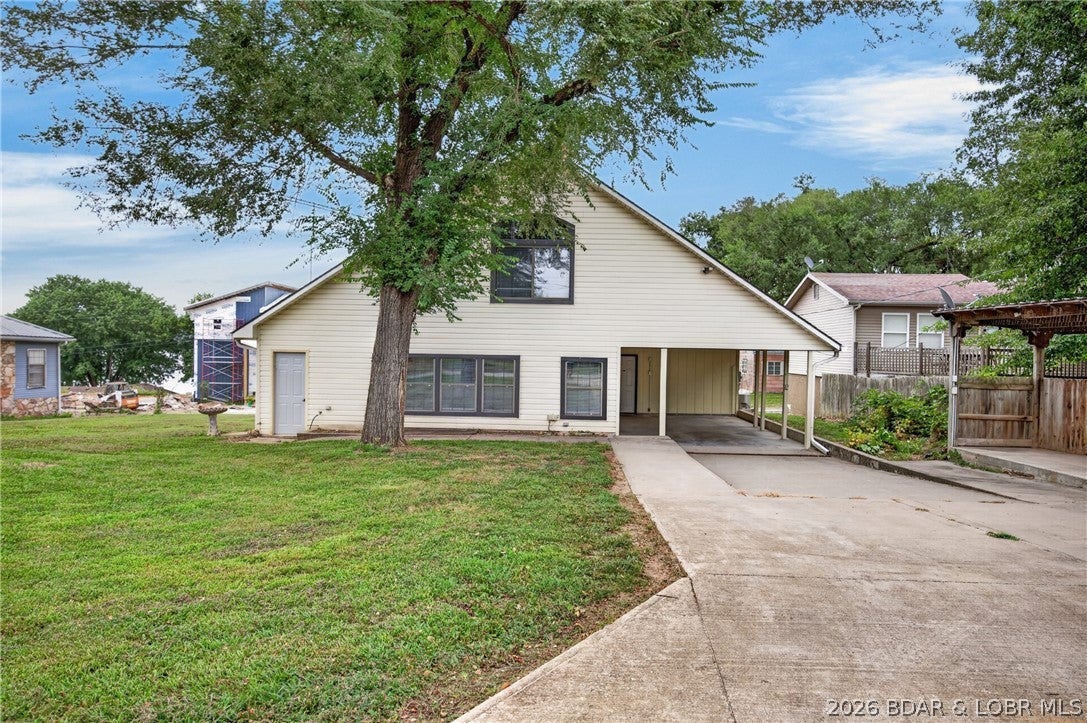 Affordable lake living with the convenience of your own private dock! Located at the 74 MM, this well-maintained home offers lake access without the lakefront price tag. The private dock is installed on the adjacent HOA lot by the subdivision boat ramp, making it easy to spend your days on the water! Tons of recent updates such as paint, trim, flooring, and carpet were recently completed in 2026 as well as a new roof in 2024, AC unit in 2023, and furnace in 2021. The main level features a huge kitchen with beautiful cabinetry, large livingroom, and spacious primary ensuite, as well as another full bathroom and laundry. Upstairs offers a versatile loft plus FIVE additional rooms that provide flexibility and tons of sleeping space! The oversized 1-car garage has a great area for storage or workshop and there is also a covered parking area doubles as a covered patio for entertainment space! Flat parking, level grass yard great for pets and kids, and a short walk to the dock! This home is great for full time living, a lake getaway or an investment property! Excellent fishing, swimming, and water sports on the 74 Mile Marker at LOZ!