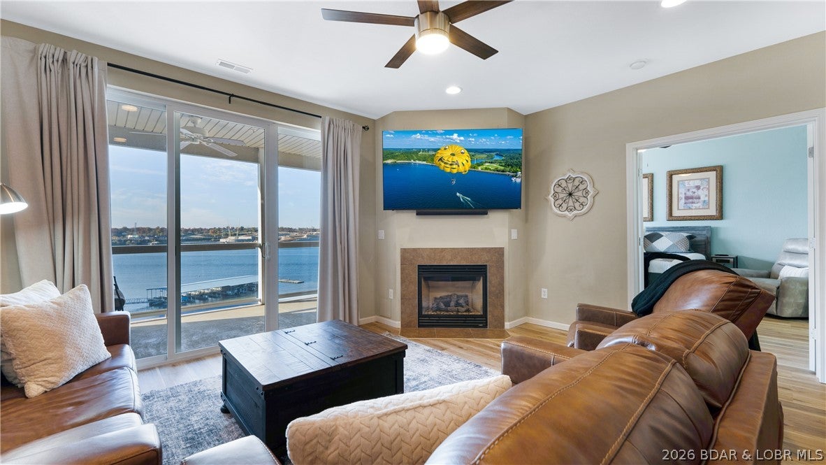 EXCLUSIVE COMPLEX & INCREDIBLE LOCATION — Beautifully updated, turn-key unit in the luxury community of Lands End is ready to enjoy or rent immediately. You will appreciate the serenity of a top-floor residence with stunning main channel views without the inconvenience of stairs, as the entry is just steps from the elevator. The open-concept layout features high ceilings and expansive lakeside windows that flood the space with natural light and showcase sweeping lake views. The oversized primary suite offers direct access to the deck and a private en-suite bath, and two additional guest bedrooms provide comfortable accommodations for family and friends. Ideally located just minutes from shopping, dining, and entertainment, and directly across the channel from the highly anticipated Oasis development. This high-demand complex features resort-style amenities including a large lakeside pool, splash pool, lazy river, playground, basketball court, and a clubhouse with fitness center and gathering space. Buy now to enjoy true luxury, maintenance-free living. A 2021 Lowe Tritoon is available for purchase separately, offering an exceptional opportunity for the complete lake lifestyle.