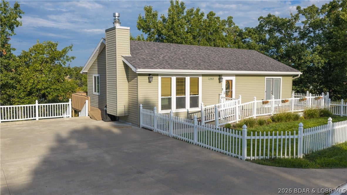 Rare opportunity to have a lakeview home with a flat fenced in front yard, flat driveway AND a private dock! It gets better... in Osage Beach! This 2nd tier remodeled 3bed/2bath home features 2 livings spaces, updated flooring throughout, new interior doors, fresh paint & a nice lakeview off the expansive deck on the back side of the home. Recently updated kitchen consists of beautiful soft close cabinets, granite counters, tile backsplash, stainless steel appliance and living room includes a newly inserted natural gas fireplace with a rock face finish. The lower-level family room features painted concrete floors, spacious utility/laundry room & walkout access to a covered patio. Patio has been recently extended with additional concrete, creating an easy transition to the storage shed. Fresh gravel alongside the patio provides even more usable outdoor space, perfect for a playground, firepit or relaxing entertainment area. Private dock is cove located w/ main channel view & features a 12x32' slip w/ swim platform, wet steps, fish cleaning station, pole holders & INCREDIBLE sunsets. Located right next to Shorty Pants, Red Head, Dog Days & State Park.Maintained blacktop roads to home