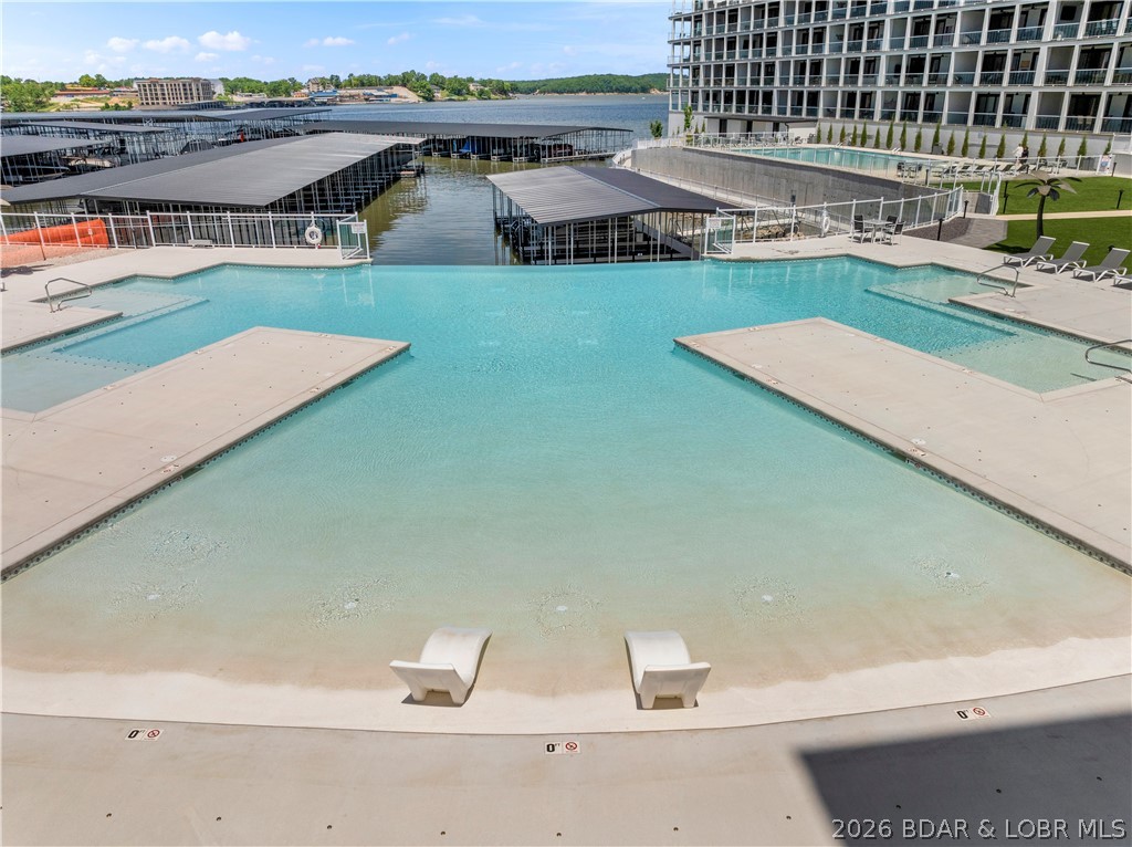 This is you chance to get a Topsider Condo at a great price before the Lake Oasis goes in. Step into easy lakefront living with this beautifully turn key bottom-level residence at Topsider. This spacious 3-bedroom, 3-bath condo offers seamless one-level living w/ an open-concept design, soaring 9-foot ceilings, & floor-to-ceiling glass that fills the main living area with natural light. Enjoy expansive main channel views from your private covered deck—an ideal space to relax or entertain while taking in the lake scenery. Inside, you’ll find granite countertops, a massive tiled walk-in shower, & a thoughtful layout that perfectly balances upscale design with everyday comfort. Topsider delivers true resort-style amenities, including a stunning waterfront pool, sun decks, luxury cabanas, fire pits, grilling areas, elevator access, and a community dock—everything you need for the ultimate lake lifestyle. Located in the heart of Osage Beach, just minutes from premier shopping, dining, and popular attractions. With rentals allowed, this property is perfectly suited as a full-time residence, weekend retreat, or a strong investment opportunity.