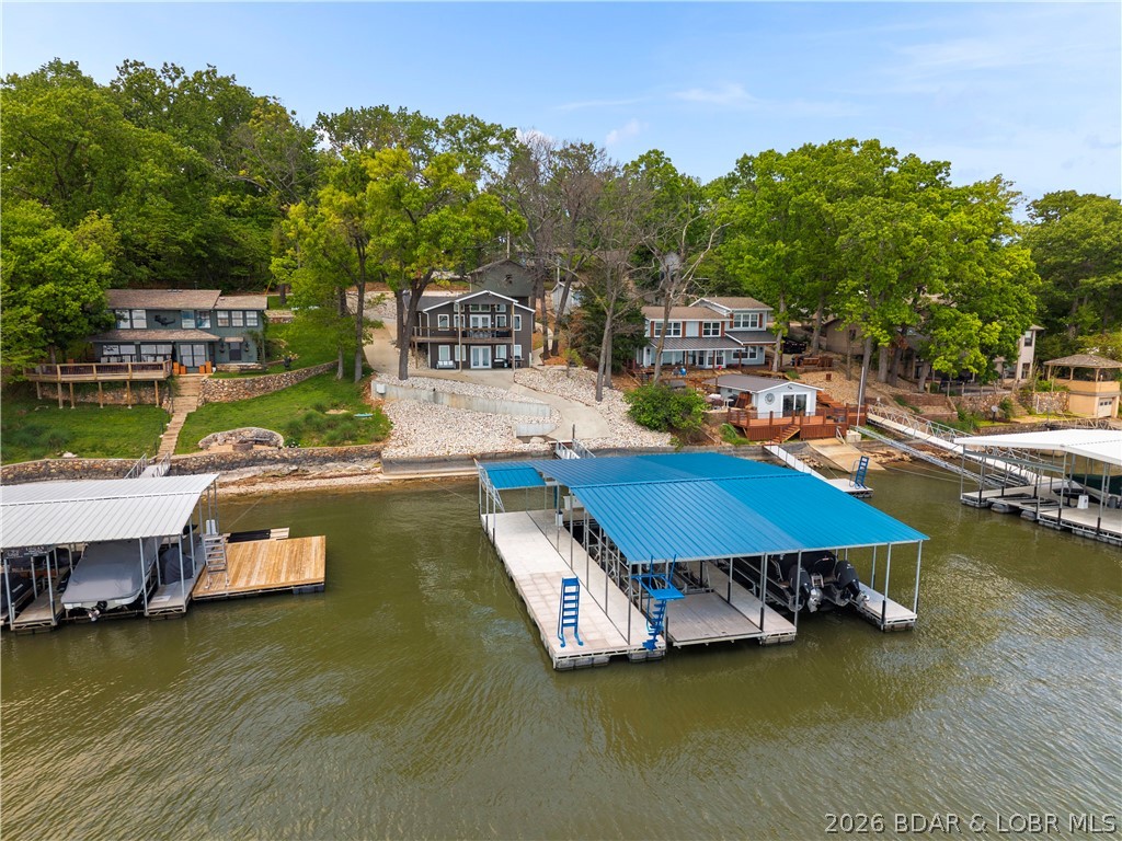 Welcome to your dream lake retreat on Island View Road! This like new 4-bedroom, 3-bathroom home offers breathtaking, unobstructed views of the main channel at the 8 Mile Marker of Lake of the Ozarks. From sunrise coffee to sunset cocktails, every moment here is framed by some of the most incredible panoramic water views the lake has to offer. Designed with modern lake living in mind, this home combines upscale finishes, open-concept living spaces, and expansive windows that bring the outdoors in. Whether you're entertaining guests or enjoying a quiet weekend getaway, this layout provides comfort, style, and functionality for family and friends alike. Perfectly positioned in one of the lake’s most sought-after areas, you’re just minutes from the action at Shady Gators, H. Toad’s, and Tap & Grill, giving you easy access to waterfront dining, entertainment, and nightlife while still enjoying the privacy and serenity of your own lakeside escape. Whether you're looking for a full-time residence or vacation home, this one checks every box. Incredible location, newer construction, and INSANE main channel views — this is Lake of the Ozarks living at its absolute best.