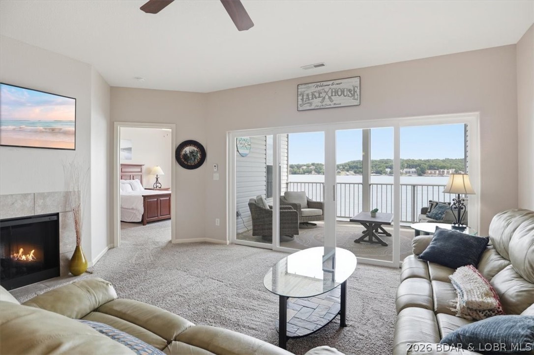 36 Foot Boat Slip with Polylift Hoist, a PWC Slip and a fully furnished turnkey 3-bedroom, 2-bathroom condominium offers effortless no-step entry and Everything You See Here is everything you get to start enjoying Lake of the Ozarks from day one. Thoughtfully stocked turnkey condo includes updated dishware, stylish furnishings, white cabinetry with crown molding, a breakfast bar, stainless steel kitchen appliances with smooth-top stove, a nice size dining room area, great room with a fireplace, and a full-size washer and dryer in the laundry room. The primary waterfront bedroom with En Suite has a double bowl vanity, a walk-in shower and these ISLAND VIEWS that only Isla Del Sol can offer to you. Two more furnished and spacious bedrooms for your guests.  Just bring yourselves and settle into lake living. Located within a gated community in a desirable area, this spacious unit features a screened-in covered deck with breathtaking main channel views that stretch for miles. The property also includes a 12’ x 36’ boat slip with a 7,000–8,000 lb. Polylift boat hoist, plus an additional PWC slip.  It's ready for you to Enjoy your Island Lake Life!