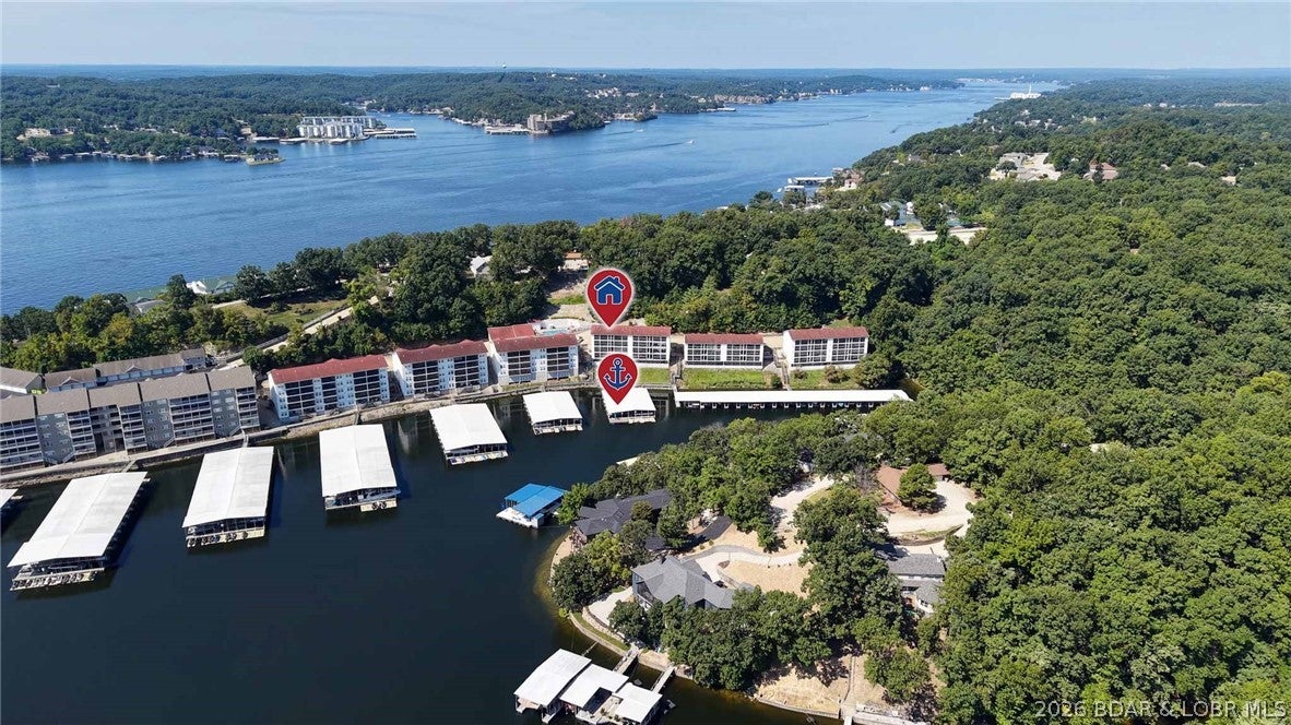 Lake life starts HERE! This beautifully maintained 2-bedroom, 2-bath condo at Lighthouse Landing is turn-key, fully furnished, and ready for you to start enjoying from day one. The comfortable layout flows right out to a lakeside screened porch—the perfect spot for morning coffee, evening cocktails, or simply kicking back and enjoying the view. Even better, a 12x28 boat slip is included, so you can be on the water and cruising in no time!  Tucked inside a quiet cove, Lighthouse Landing offers calmer water that’s ideal for swimming, fishing, kayaking, and paddle boarding. Enjoy the heated community pool, large designated pet areas, and a fantastic location just minutes by land or water from the restaurants, shopping, entertainment, and attractions of the Bagnell Dam Strip. Nightly rentals are allowed, giving you the flexibility to enjoy it yourself while also taking advantage of rental income potential. Whether you’re looking for a weekend getaway, full-time lake living, or an investment property, this affordable lake condo checks all the boxes. Bring your suitcase and start making lake memories!