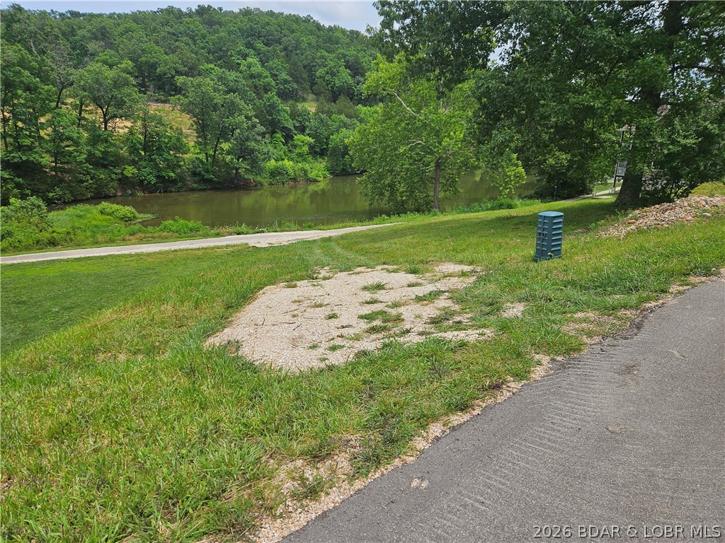 It's really, really hard to find a lake front lot like this. Quiet cove located 5 minutes from restaurants, banks, shopping & entertainment. The Nauti Fish and Cave waterfront bars are less than a mile away. Subdivision has central water & sewer, clubhouse, pool, sand beach.  The lot comes with a dock slip and pwc spot. Single family dwellings only and building plans must be approved.  Access to the clubhouse and pool is restricted until a home foundation is installed.