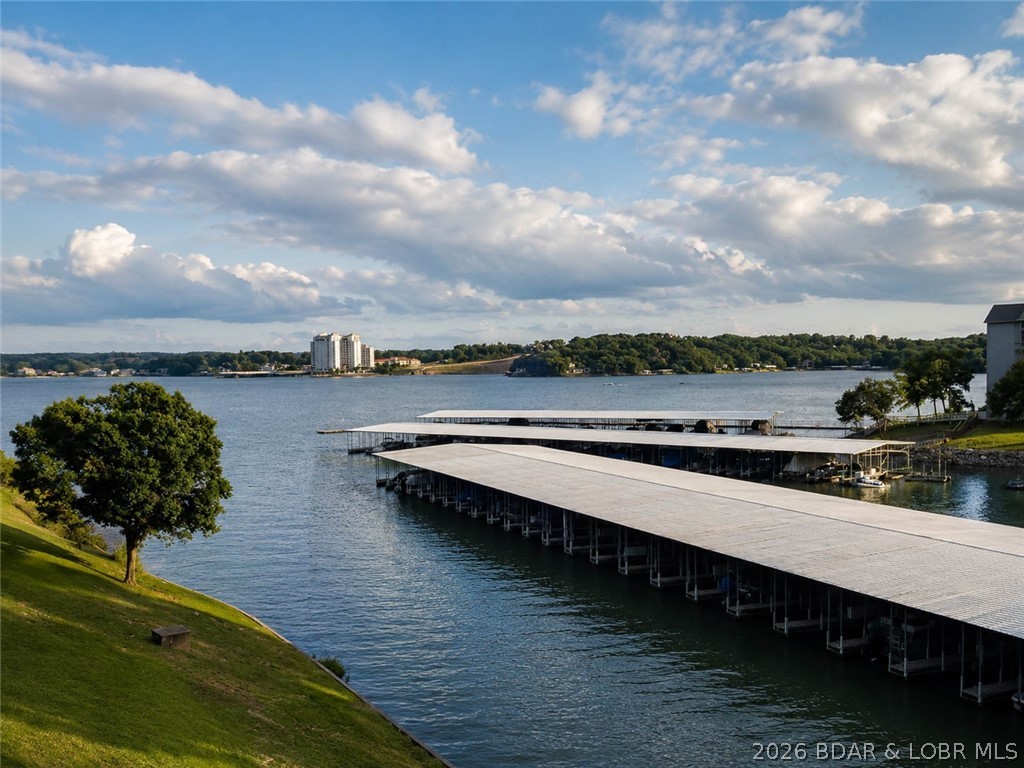 Enjoy lake life at its best in this beautifully updated 3-bedroom, 3-bathroom condo that is truly move-in ready. This spacious, turn-key property offers an open floor plan, comfortable living spaces, plenty of room for family and friends, and a walk-in level entry for easy access. The updated kitchen features granite countertops, soft-close cabinets, and a larger pantry, making it both stylish and functional. You'll also appreciate two large storage areas, providing plenty of room for all your lake toys and essentials. Step outside and take in the lake views from your Suntastic window enclosed deck, complete with an outside full-size refrigerator-perfect for entertaining and keeping drinks cold after a day on the water. Then head down to your boat dock by car and enjoy a day on the water. Whether you're looking for a full-time residence, weekend getaway, or investment opportunity, this condo has everything you need to start enjoying the Lake of the Ozarks lifestyle from day one. Just bring your suitcase and start making memories!