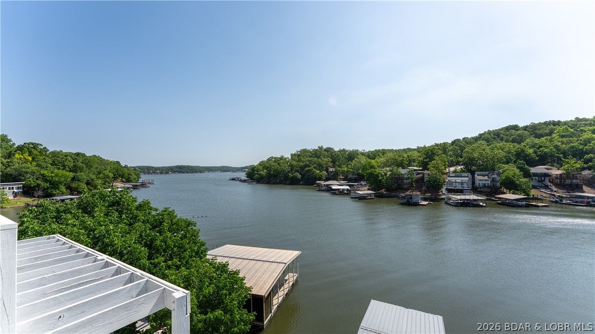 Check out this incredible investment opportunity to own a versatile 4-unit property located right on the water. Whether you're looking to operate a multi-family rental, a spacious single-family home, or live in one unit while renting out the others, this property offers endless possibilities. Enjoy stunning views of the main channel from every level. Completely updated in 2025, the property features luxury vinyl plank flooring, granite countertops, new appliances, siding, roof & more. Each of the 4 units has a private entrance & deck. Unit #1, located on the lowest level, is a studio apartment with a full kitchen & bathroom. Unit #2 includes 1 bedroom, 1.5 bathrooms, a full kitchen, & a living area. Unit #3 also features 1 bedroom, 1.5 bathrooms, a full kitchen, & a living room. Unit #4, situated on the top floor, offers 2 bedrooms, 1.5 bathrooms, a kitchen, & a living area. A shared common area includes a laundry room & interior staircase connecting units. There is plenty of parking with 3 spots directly in front of the house and an additional 4 Parking spots located just above the house on Ginger Rd. The Seller is Motivated! Bring Offers!