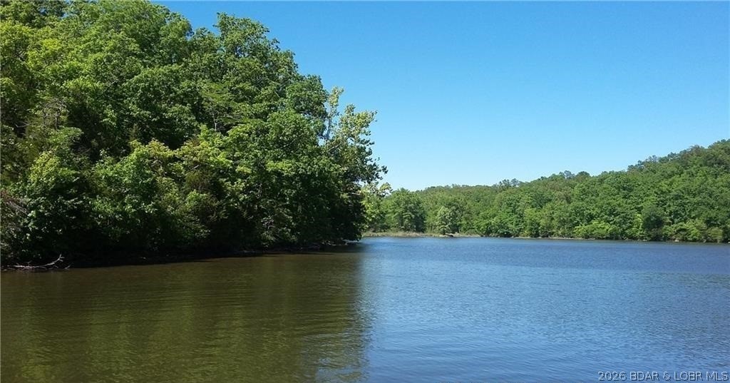 HUGE REDUCTION! 2,089 feet of gentle shoreline & 17.73 acres of beautiful Lake of the Ozarks land. This exceptional property features a mix of open pasture, valley, hay fields, mature trees, and a spring-fed creek, creating a peaceful and private setting. Abundant wildlife including deer, turkey, and ducks make this an ideal retreat for nature lovers and outdoor enthusiasts. Enjoy fishing, kayaking, and wide-open space to roam. Must provide proof of funds & a scheduled appointment only. Sellers agent, owner to accompany all showing (camera/videos on property). Property is occupied and hunted! Trustee for the trust is a licensed real estate agent. DO NOT try to enter property off of Heather rd. and private driveway.