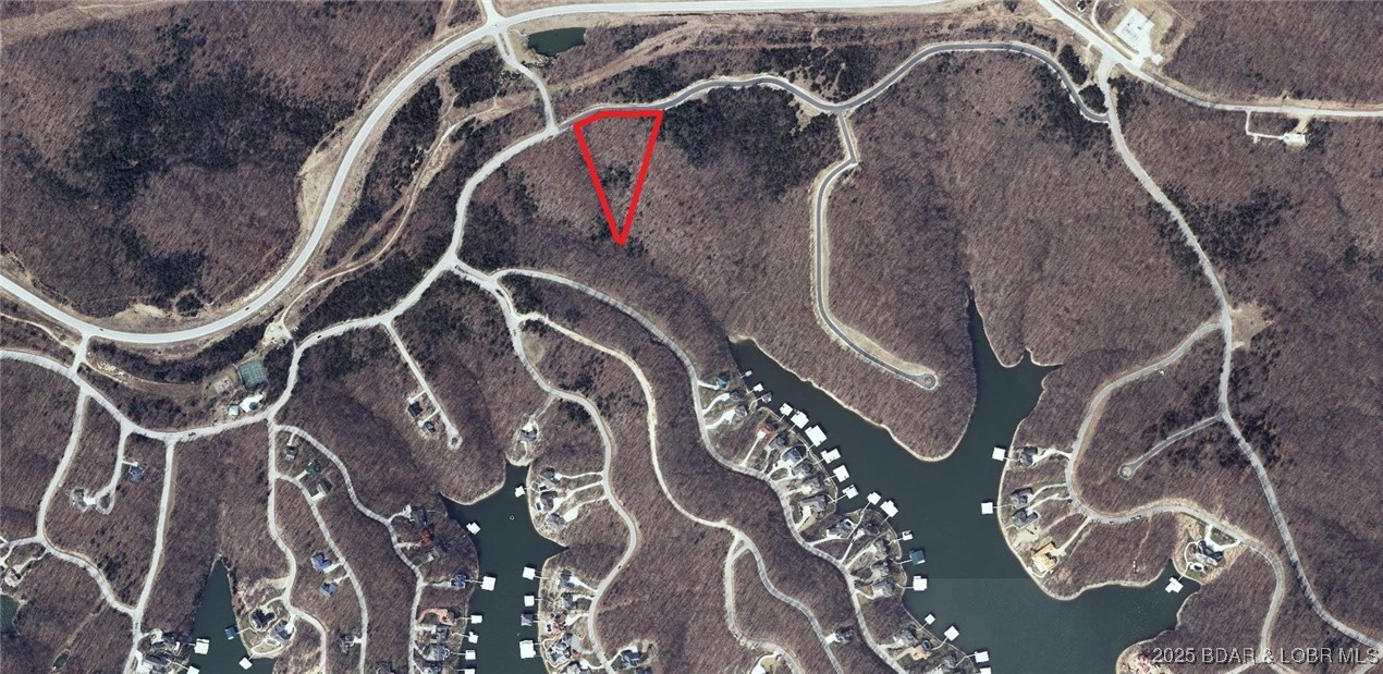 Close your eyes. Picture yourself owning a private, wooded estate in the Lake of the Ozarks’ most coveted neighborhood—The Villages at Shawnee Bend. Envision the legacy you’ll build for your posterity with your own private gated entrance bearing your family name with the lake’s most exclusive address: Villages Way. What if I told you it’s not just a homesite—but literal acreage—now available in the brand-new Villages Way Estates? We are offering an extraordinarily rare chance to secure a secluded estate tract that guarantees absolute privacy, and may well prove to be one of the wisest investment of your life. The Villages at Shawnee Bend isn’t merely the finest community at the lake; it’s also the most centrally located. Minutes from the four-lane, it delivers unmatched access by land and water, plus the region’s fastest fiber-optic internet. Utilities are available to build now: water, sewer, natural gas, high-speed fiber—while resort-caliber amenities await: pool, pickleball and tennis courts. Ownership comes with access to boat slips at nearby Harbor Nineteen, Shawnee Bend’s most anticipated waterfront destination. This is, without exaggeration, a once-in-a-lifetime opportunity.