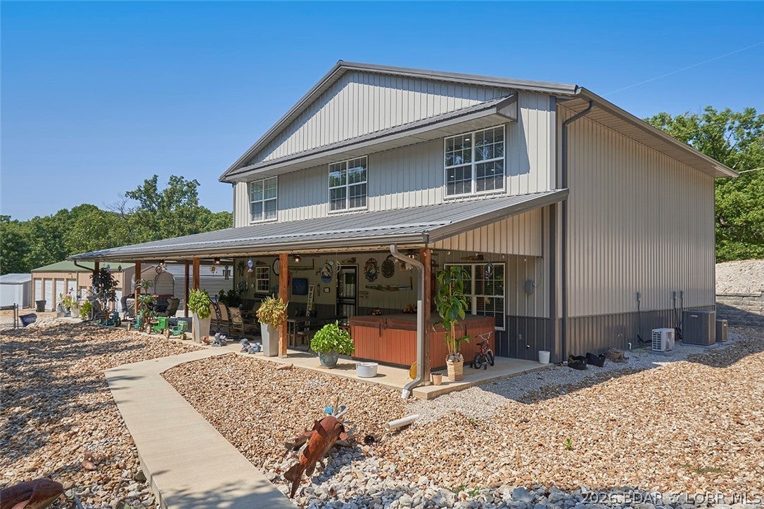 Room for the whole family and then some! Nestled on 2.04 peaceful acres with paved road access, this approximately 3-year-old shouse was built with family gatherings in mind. Offering 5 bedrooms, 2.5 baths, and bedrooms on both levels, there's plenty of space for everyone to spread out. Inside, you'll find 9-foot ceilings on the main level, rustic cherry cabinetry, and a kitchen pantry. Step outside to the expansive covered patio, perfect for relaxing, entertaining, and making memories. Need room for your toys, hobbies, or equipment? You've got it! The property includes an attached 14x28 garage, a 24x32 shop, additional outbuildings, and an impressive storage building featuring multiple individual units with concrete floors, power, and lighting. The storage units also present potential rental income opportunities that could help offset ownership costs. Whether you're looking for a place to gather, room to work and play, or extra income potential, this property offers the space and flexibility to make it your own!