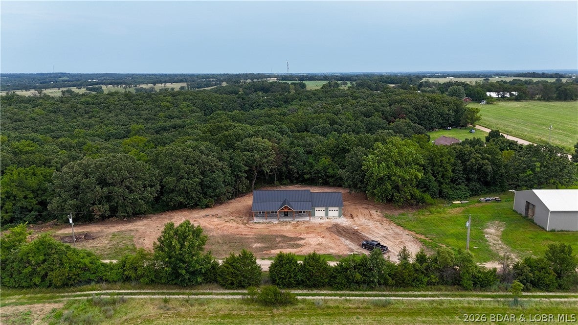 For Sale—New Construction on 3.8 Acres in the Eldon School District! This quality-built, 1,500-square-foot home features durable board-and-batten steel siding and a steel roof with no exposed fasteners. Inside, you’ll find an inviting open floor plan, a spacious kitchen with an island, pantry, and included appliances, plus a convenient laundry room with a utility sink. The private primary suite offers dual sinks and a walk-in shower. Additional highlights include an all-electric HVAC system, a large 27' x 28' garage, and a level yard with plenty of room to enjoy country living. Don’t miss this beautiful new home! To Do: install appliances, seen and straw the yard, place back deck, survey and New 911 address.