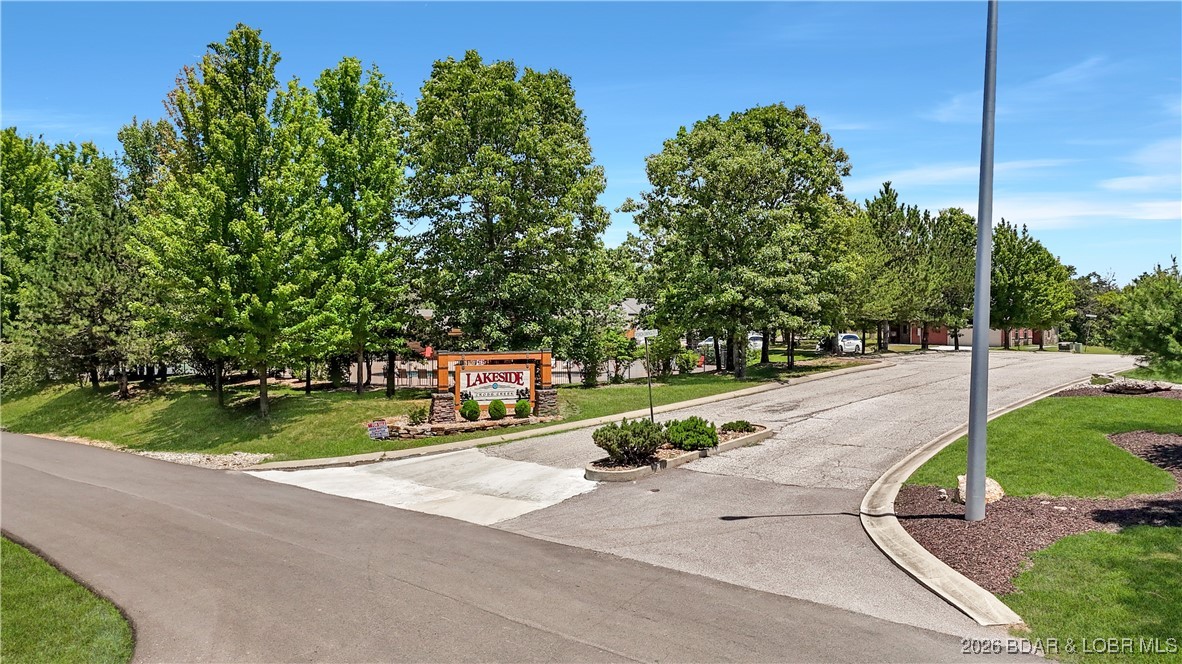 Welcome to Lakeside at Cross Creek, a premier gated community offering a rare opportunity to build in a peaceful yet highly convenient Lake of the Ozarks location. This buildable lot is surrounded by newer homes and quality construction, with access to shared amenities including a pool, tennis courts, and clubhouse. Sewer and well hookups are available, and builders are on hand to help bring your plans to life. Located between Camdenton and Osage Beach and within the Camdenton School District, this property offers both privacy and long-term value.