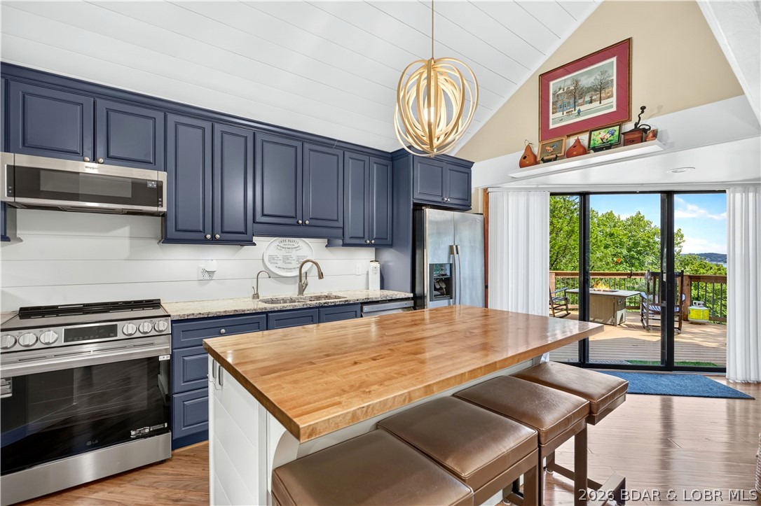 Distinctive architecture meets effortless lake living in this beautifully updated 2.5-story octagon-style home in the desirable Treetop Subdivision. Surrounded by mature trees and filled with natural light from an abundance of windows, this one-of-a-kind residence offers 3 bedrooms and 2.5 bathrooms in a setting that feels both private and connected to the beauty of the Lake of the Ozarks. The recently updated interior features a stunning new kitchen and rich hardwood floors throughout the main level. Step outside to the expansive deck, where a view of the lake provides the perfect backdrop for morning coffee, quiet evenings or entertaining guests. A 10x28 boat slip makes enjoying the water effortless. Residents also enjoy two community outdoor pools and access to all Four Seasons amenities. The HOA adds convenience by covering sewer, trash, and basic cable and internet. With its distinctive design, refined updates, lake view and exceptional amenities, this is a truly unique opportunity for sophisticated lake living.