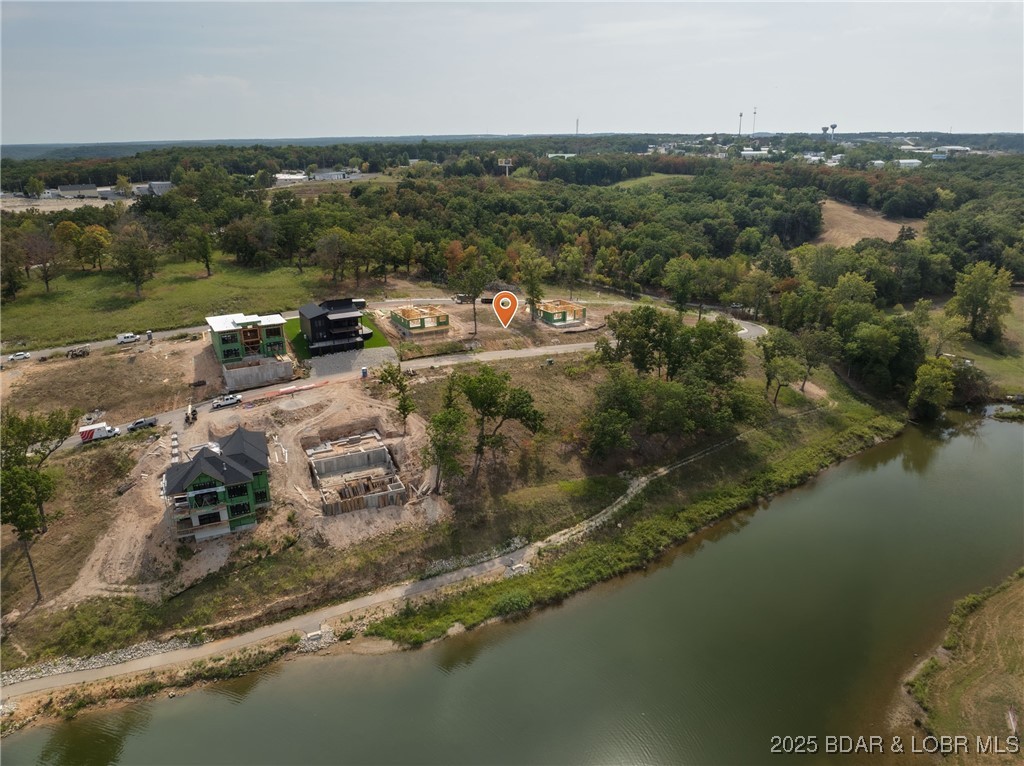 Come build your dream home or use the sellers current plans in the newest lake community at Lake of the Ozarks! Harpers Cov in Osage Beach provides lakeside pool with clubhouse, community docks all accessible by your golf cart  for easy access around the community and to the docks.  City water, city sewer, city maintained streets, natural gas, community trash, sidewalks, streetlights, and highspeed internet.   This Lot one of the larger second tier lots (81x110x83x110) with gentle slope - would make an ideal walk out!.  Minutes from Hospital, shopping, restaurant's and popular lakefront attractions. Great location by land and water.  12x36 dock slip available.