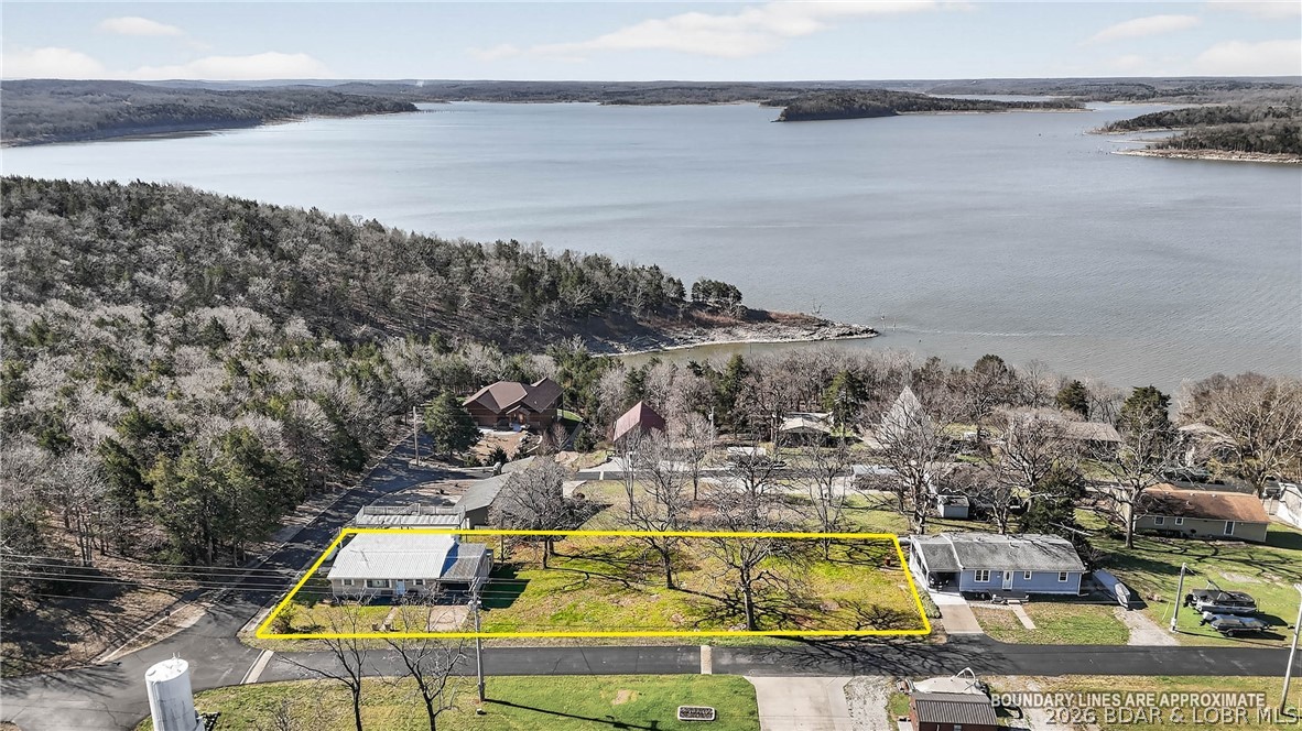 Super sought out location on Truman Lake with additional lots, this 3-bedroom home located in the highly desirable Pom Osa Heights neighborhood with convenient community boat access. Just down the road from the community boat ramp, this property offers easy access to fishing, boating, and lake recreation. The home features a spacious sunroom filled with natural light and a large fireplace, creating a warm and inviting atmosphere year-round. A unique multi-level deck provides excellent outdoor living space and captures beautiful views of Truman Lake—perfect for relaxing or entertaining. Large, additional lots offer an opportunity to build the perfect shop for all your toys and tools! Located less than 20 minutes from Warsaw and under 2 hours from Kansas City, this property offers a great balance of peaceful lake-area living with convenient access to nearby amenities. Don’t miss this opportunity—schedule your private tour today!