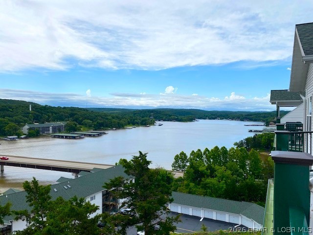 I Loved this VIEW when I lived in this area….watching the boats on the lake, seeing the cars cross the bridge, enjoying the changes of the season…so much diversity from this VIEW.  Now you have the chance to have that same love…this 3 br, 2 bath TOP FLOOR END unit provides endless VIEWS, even from the kitchen & upper loft area!  Walk through the private foyer to your 1596 sf living area.  The open floor plan is grand w/ its vaulted ceiling & full wall of windows. The deck is spacious for evening entertaining & this unit has a screened in porch for gnat free enjoyment.  A double door welcomes you into your primary suite, w/ access to the porch & a large bath & closet.  BR 2 & 3 have decent closet space for guest belongings & share the main bath.  The upstairs loft expands the grandness of this condo, offers more space & more views. The complex has 2 community pools, boat docks, dog park & allows nightly rentals through its HOA registration program & is convenient to golf courses, restaurants, entertainment & of course shopping!  The traditional feel of this condo, and the warmth of the fireplace, is comfortable & is an opportunity for LAKEFRONT living w/out the lakefront price!