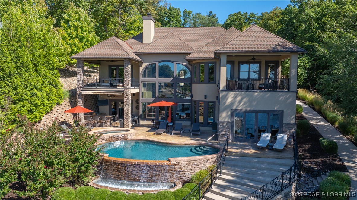 In The Villages at Shawnee Bend, this Lakefront estate blends luxury and lifestyle on over ¾ acre with 154 ft of shoreline, southern exposure, deep water, and excellent cove protection. With 6,788 sq. ft. this estate offers 6 Bedrooms, 6 Full Baths, and 3 Half Baths across a flowing “reverse” style floorplan that puts all the main living areas just steps away from the pool, lake and dock. Elegant finishes include Italian marble floors, two story barrel vault ceilings and 5 fireplaces. A gourmet kitchen features GE Monogram appliances, hammered copper sink, granite counters, Kraft Maid cabinetry, and large pantry. Two lakeside master suites provide direct patio/deck access, spa-inspired baths with oversized marble showers, beverage centers, and custom closets. Additional highlights include a wine cellar, sunroom with fireplace and tumbled stone flooring, and a grand wrought-iron staircase. Outdoor living is unrivaled with a heated infinity-edge pool, 10-person hot tub, outdoor kitchen, stamped concrete patios and lush professional landscaping.  Take the cart path to the huge dock with 20x55 slip and deep water.  This property is ready for you to make it your own!