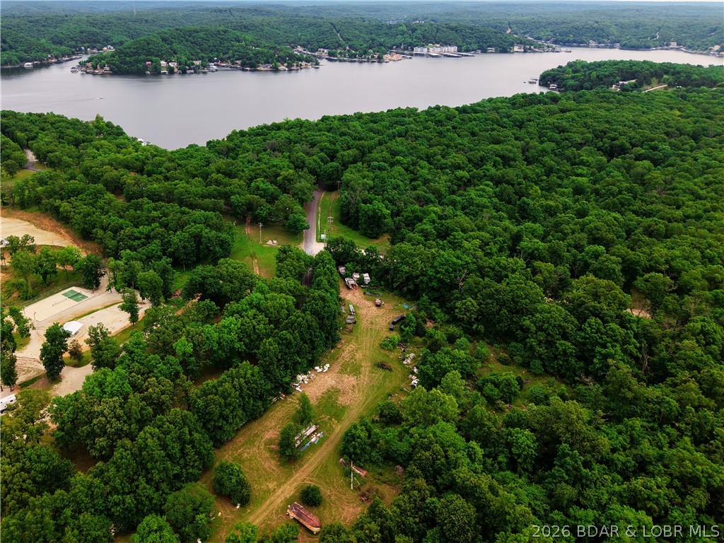 Tired of paying campground fees year after year? These mostly level half-acre lots offer a different option — own your own piece of the Lake area and enjoy the freedom to set it up your way. Located directly across from Mermaid Cove Campground, these lots put you just a short golf cart ride from the marina, Lake Burger, and all the fun that keeps people coming back to the area every season.

Seller is currently working toward establishing shared well lines and electric service access, making these a great opportunity to get in early while improvements are underway. The front portion is already cleared for easier access and setup, while the wooded back section adds privacy and a more relaxed feel than being packed into a traditional campsite.

Enjoy seasonal lake views, room to spread out, and the flexibility to create your own weekend retreat or future getaway spot without being stacked right on top of your neighbors. Whether you're already spending your summers at Mermaid Cove or looking for an affordable way to enjoy the Lake lifestyle, these lots are worth a look.