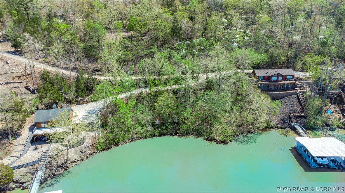 Build your dream lake getaway on this beautiful lakeview lot located on the quiet side of Lake of the Ozarks. With wide water views, peaceful surroundings, and the kind of privacy that’s becoming harder to find, this property offers the perfect backdrop for your future lake home. This lot gives you the space and setting to bring your vision to life. Picture slow mornings with coffee overlooking the water, relaxed afternoons surrounded by nature, and quiet evenings taking in the sunset.
You’ll enjoy the calm of the quieter side of the lake while still being close to the places that make lake life so special. By water, you’re near favorites like The Cave Restaurant, Nauti Fish Rum Bar, Larry’s on the Lake, and the iconic Bridal Cave. By land, grab breakfast at Rise & Shine Cafe, spend the day exploring Ha Ha Tonka State Park, or stop by local favorites like the Hillbilly Hut or Burger Basket on your way home.
This is the kind of property that lets you slow down, spread out, and enjoy the lake lifestyle at your own pace. Potential added bonus: the adjoining lot is also available, giving you the opportunity to expand your footprint even more.