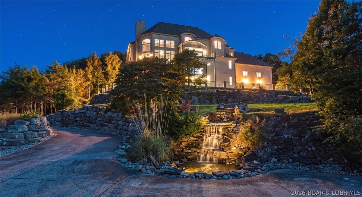 Setting the tone for this extraordinary estate are magnificent lake views, best enjoyed from its multiple expansive decks. Full of grandeur & exquisite design, the famous Castle House in Old Kinderhook is a majestic 9,400-square-foot luxury sanctuary sitting at the highest elevation in this prestigious gated community. Spanning 2 premier lots, views from 5 spacious decks, while 95 acres of woods directly behind offer ultimate privacy.  Inside, grand vaulted ceilings, fine Italian marble, travertine tile, a cherry wood elevator, and two gourmet kitchens highlight the home's exceptional craftsmanship. The layout boasts 8 bedrooms and 8 distinct gathering spots, perfectly balancing group entertaining with quiet personal space. Premium amenities include an indoor basketball court, a movie theater, and a private wine room. Beyond serving as a dream primary residence, this estate is a proven, turn-key business generating outstanding rental income with established Superhost & Premier Host status. A dedicated website will also convey to the new owners. Located just a golf cart ride from Old Kinderhook's pools, fine dining, marina, this iconic estate is an unbeatable investment opportunity.
