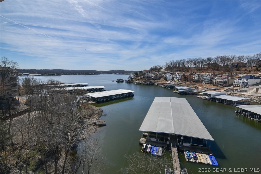 Fantastic Top-Floor Condo with Stunning Lake Views & Two Boat Slips in Regatta Bay! Beautifully maintained 2-bedroom, 2-bath condo in the highly sought-after Regatta Bay community. Enjoy breathtaking views of the cove and Main Channel—perfect for watching boats cruise by or taking in sunsets from your private screened-in deck. This property is truly a great find, offered fully furnished with two boat slips—a 12x32 slip w/ hoist & a 10x30 slip w/ PWC lift—the ultimate turnkey package for a vacation getaway, full-time residence, or income-producing investment. Regatta Bay offers an exceptional lifestyle with resort-style amenities, including: two pools (one waterfront and one at the clubhouse), pickleball & tennis courts, playground and expansive greenspace with pet-friendly stations, covered picnic areas and lakeside pavilion-perfect for enjoying seasonal fireworks and more! Set on 13 beautifully maintained acres, there's plenty of space to relax, walk, and play. Conveniently located by both land and water, just minutes from everything Lake of the Ozarks has to offer—the Bagnell Dam Strip, dining, shopping, grocery stores, entertainment, and state parks.