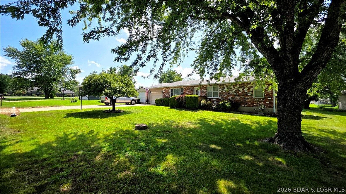 This lovely home is located in a fantastic neighborhood and move in ready. Beautiful hardwood floors throughout the first floor, updated kitchen cabinets & countertops, comfortable living room, dining room off the kitchen and the whole basement that can be whatever your family needs! There is an additional sleeping area in the basement with a bath. And the walk in, sit down jetted tub in the first-floor bath is a huge bonus! Laundry on both levels! You will love the covered deck area in the back yard, and the patio with the hot tub! Nice yard with a storage shed. The attached garage has room for 1 car and a workshop in the back for projects! There is an additional single car garage shop included. This one will check all the boxes and will fit your Lifestyle! Schedule your showing today!