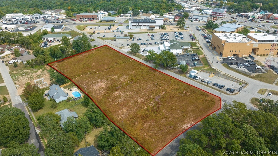 Prime commercial and multifamily development opportunity in the heart of Camdenton, just off the square and directly behind the Camden County Courthouse. This C-2 zoned property offers exceptional flexibility for a mixed-use development, with potential for retail, restaurant, or office space at street level and multifamily apartments above and below. The site’s natural topography is ideally suited for walkout lower-level units while providing ample parking, potentially allowing developers to maximize usable space and create multiple income-producing opportunities. Minimal excavation and site work further enhance the property’s development potential. Excellent visibility from Ha Ha Tonka Cut Thru, along with prominent existing signage, provides valuable exposure in a high-traffic location. With strong demand for commercial space and multifamily housing, this property presents a rare opportunity to create a versatile, income-producing development in one of Camdenton’s most desirable locations.