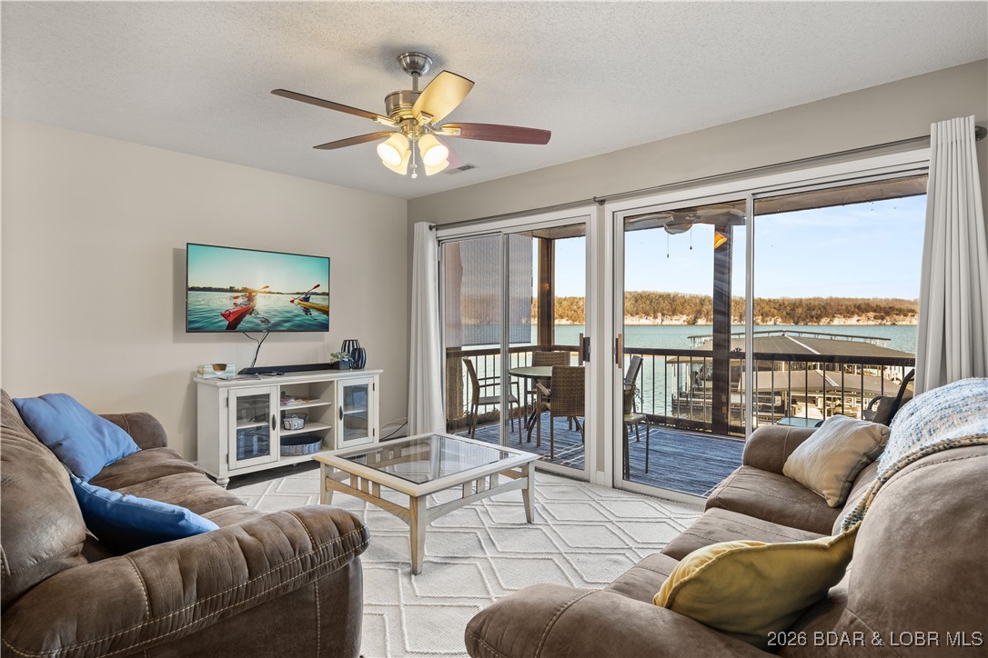 Enjoy lake life at its finest in this beautifully styled 3-bed, 2-bath lakefront retreat located in the desirable Breakwater Bay Club Condominiums at the 22-mile marker.  You’ll love the open-concept living & kitchen area, This turn-key condo is fully furnished, nightly rental approved & offers ample parking, making it an ideal investment or personal getaway. Upgrades include a screened-in porch, laminate flooring, modern interior doors & fixtures, & beautifully refreshed bathrooms. Natural light fills the space thanks to the expansive glass slider in the living room & oversized bedroom windows. The spacious second bedroom easily accommodates a queen & full bed, making it perfect for families or guests. The lakefront primary suite features floor-to-ceiling windows,  private bath, & direct access to the deck—an ideal spot to enjoy morning coffee or sunsets. Residents enjoy access to an oversized community pool, clubhouse, & playground, just steps away. Whether you’re seeking a relaxing retreat or a rental opportunity, this condo delivers the total lake package. *Bonus: Seller to make last two HOA payments of 2026. Make your lake dreams a reality! *See rental revenue projection.