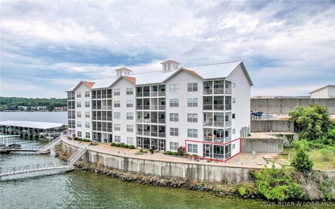 Welcome to Isla Del Sol! This desirable lower-level end unit offers privacy, easy access, and breathtaking unobstructed lake views with no docks blocking your view. Being the last unit on the end means less foot traffic, while the screened-in patio is the perfect place to relax and enjoy amazing sunsets.

Located at the 3 MM on a gated island, Isla Del Sol offers incredible views for miles and is just minutes by water from popular waterfront restaurants. Enjoy the large community pool, patio areas, grills, and fire pits. This unit is conveniently located just steps from pool, and the elevator.

Inside, the open floor plan flows from the dining area and kitchen into the living room with an electric fireplace, then out to the screened patio and incredible lake view. The spacious primary suite features a walk-in closet, jetted tub, double vanity, and large shower.

Perfect for full-time living, a lake getaway, or an investment property. Nightly vacation rentals are allowed, offering great rental potential. Come enjoy the privacy, convenience, amazing sunsets, and unforgettable views from this unique unit at Isla Del Sol!