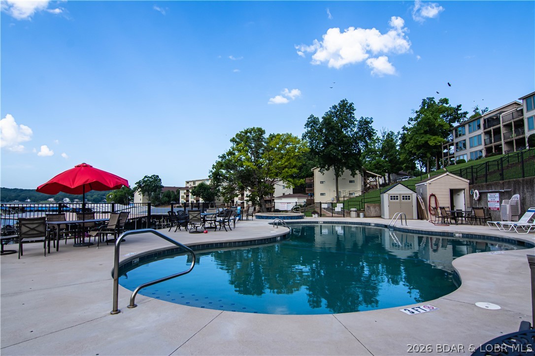 PERFECT LAKE PACKAGE!!! Turn Key Condo that includes 10x24 boat slip, 2 PWCs, remote lift, and dock box for
storage. Start enjoying the Lake on DAY ONE! This beautifully updated 2 bed, 2 bath condo comes fully
furnished and move-in ready—just bring your flip flops. Enjoy breathtaking views from your spacious lakefront
deck, perfect for entertaining or relaxing with a drink in hand. Walk out directly to the heated saltwater pool
from your deck—an unbeatable feature! The fully stocked kitchen boasts updated cabinets and laminate wood
flooring. Recent upgrades include a new range, refrigerator installed in 2018, HVAC installed in 2019, and a
full-size washer & dryer installed in 2024. The complex offers resort-style amenities: 2 sparkling pools, 2 hot
tubs, and a lighted boardwalk for evening strolls. Close to restaurants, marinas, and local entertainment.
Whether you're looking for a serene getaway, full-time home, or income-producing rental, this gem checks all
the boxes!