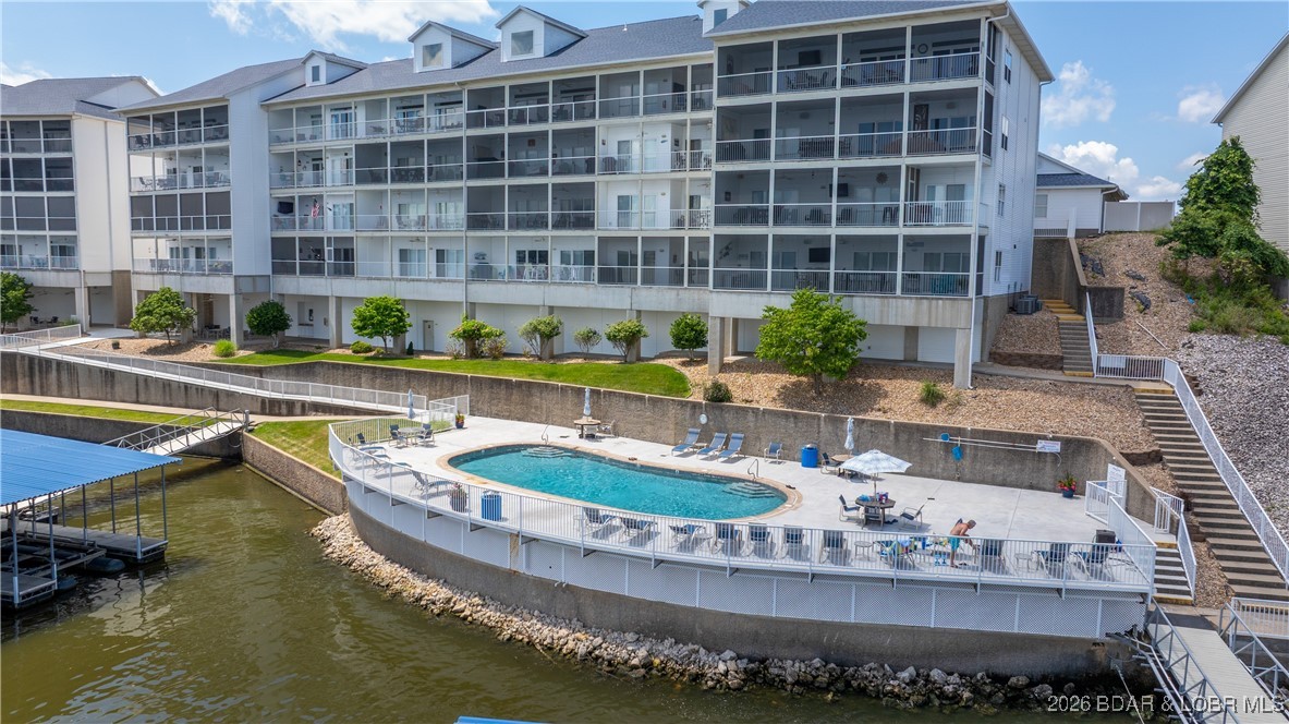 The Lake lifestyle in Osage Beach is incredible because of its accessibility by land & water to all the most popular places are minutes away AND here, you get to enjoy ZERO maintenance living! This gated & well maintained condo complex offers stunning views of the Osage 20MM AND has elevator access from the parking lot to the pool level and zero steps to the docks! This unit also includes a 12x30 boat slip! By water, you're just around the corner from the Lake’s most popular restaurants and only 1 mile from the soon to be Lake Oasis amusement park; location is hard to beat! This updated 3 bedroom, 2 bath lower-level unit is energy efficient and has many recent updates like new LVP flooring, a stone-faced fireplace, tile backsplash & fresh paint.  No nightly rentals allowed which ensures you a quiet, owner-focused community. Lake side you get a large covered patio space, lakeside walkways and of course the breathtaking views, making this a great opportunity for you to get on the water and start making memories. By land you're near grocery, additional popular restaurants, more entertainment and quick highway access.