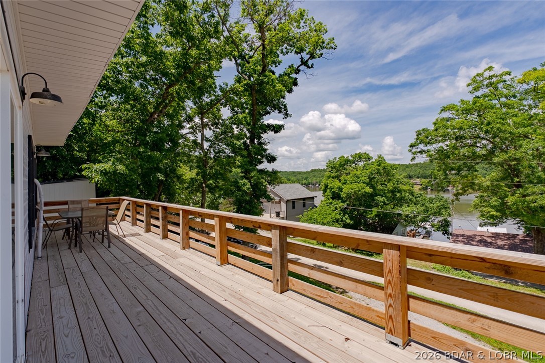 Lake views, extra space, and endless possibilities! This newly updated 2-bedroom home is located in peaceful Lick Creek Cove at the 66 MM of Lake of the Ozarks. Enjoy beautiful water views from the expansive 40x8 lakeside deck, perfect for relaxing, entertaining, or watching the sunset. A 10x12 rear deck provides additional outdoor living space.
Inside, the open kitchen and living area is filled with natural light from numerous windows, creating a bright and inviting atmosphere. Community lakefront access is just across the street, with a boat ramp at nearby Bottoms Up Marina for easy access to the water.
The oversized second lot offers plenty of room to build a garage, workshop, man cave, she shed, or expand the home. Located in a quiet neighborhood known for great fishing and calm waters, you'll enjoy kayaking, paddleboarding, swimming, and all the fun the lake has to offer. Whether you're looking for a full-time residence, weekend getaway, or investment property, this lake-view retreat is ready for you to start making memories.
