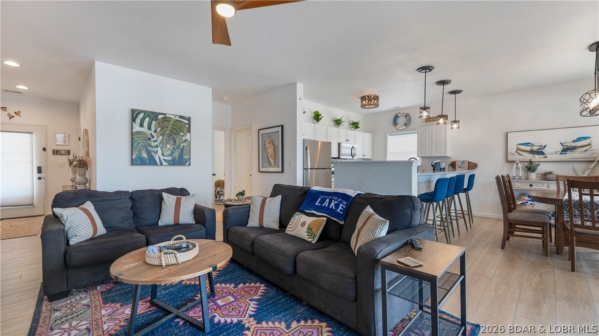 SELLER IS OFFERING A 2/1 RATE BUYDOWN - lower your payment and start enjoying Lake life sooner! Wake up to sweeping main channel views from this updated top-floor end unit at Regatta Bay, with privacy, income, and turnkey living. This 3-bedroom, 3-bath condo has generated more than $154,000 in gross rental revenue since March 2023 - a Lake retreat with proven rental potential. No neighbors above or on one side means extra peace and natural light throughout the bright, open floor plan. You will love the luxury vinyl plank flooring, quartz countertops, stainless appliances, cozy fireplace, and stylish finishes. The spacious primary suite includes a walk-in closet and private bath, while two additional bedrooms and baths give family and guests room to spread out. Step onto the large lakeside deck, then head to your 14x36 boat slip located behind the building. Offered fully furnished and turnkey, this is ready to enjoy or continue renting. Regatta Bay offers pools and a clubhouse near H. Toad's, Shady Gators, the Bagnell Dam Strip, shopping, dining, and entertainment. Don't wait - opportunities with views, income history, a big slip, and a buydown do not come along often!
