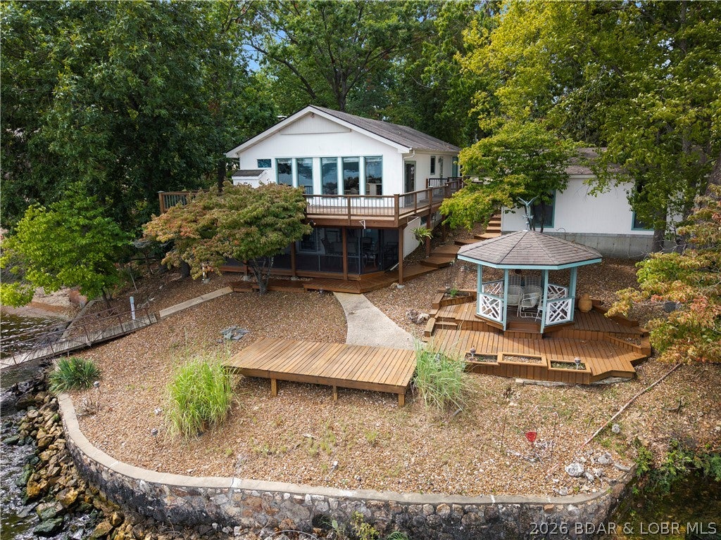 This is the kind of lakefront opportunity that is becoming harder to find in the heart of Osage Beach. Situated on an incredible double lot at the 22 Mile Marker, this charming home offers the space, setting, and unforgettable views to create something truly special. With good bones and tons of potential, the home is ready for a creative eye to transform it into the lakefront retreat you've always envisioned. Two levels of living provide plenty of room to spread out, entertain, and host family and friends, while expansive lake views create a backdrop that simply can't be recreated. Whether you choose to update the existing home, reimagine the spaces, or make it entirely your own, the possibilities here are hard to overlook. Best of all, you're positioned in a prime Osage Beach location close to some of the Lake's most popular restaurants, entertainment, shopping, attractions, and waterfront hot spots. With a double lot, incredible views, ample space, and a location that puts you in the middle of it all, this property is an exceptional opportunity to bring your vision of Lake of the Ozarks living to life.