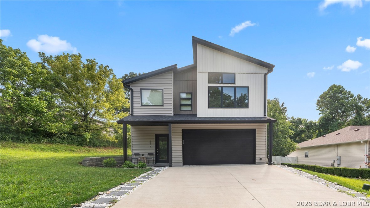 Just four years old — this 3-bed, 2.5-bath Osage Beach home has already settled into itself. Vaulted ceilings and an open floor plan flood the main level with light. Custom cabinetry, honed granite counters, and statement fixtures set a polished but welcoming tone. The kitchen features stainless appliances and an oversized island. All three bedrooms sit upstairs alongside the laundry room — smart layout, no hauling baskets downstairs. The primary suite offers a walk-in shower and a walk-in closet built to stay organized. Minutes from groceries, schools, and shopping, with lakefront dining and entertainment close enough to be spontaneous. Tucked into Whispering Streams, the home feels quiet and private — a backyard with a patio gives you room to grill, garden, or unwind. Four years old, energy-efficient, move-in ready.