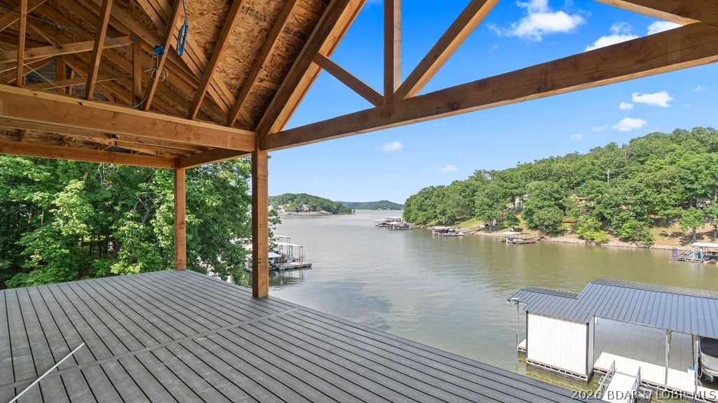 Experience lakefront living at its finest in this stunning new construction luxury home featuring 6 bedrooms, 6.5 bathrooms, and three expansive levels of thoughtfully designed living space. Every bedroom is an en suite, offering unparalleled comfort and privacy for family and guests alike. Perfectly positioned to capture breathtaking lake views, this exceptional property boasts a massive dock, direct lake access via wraparound exterior stairs, and a spacious screened upper deck designed for year-round enjoyment. The open-concept floor plan seamlessly blends elegant finishes with modern functionality, creating the ideal setting for entertaining and relaxation. Additional premium features include wiring for two electric vehicle charging stations, hot tub readiness, and high-end construction throughout. Whether you're seeking a luxury full-time residence, vacation retreat, or investment opportunity, this extraordinary lakefront home delivers the ultimate waterfront lifestyle. Located on the 35 MM of Lake of the Ozarks. NO HOA! Call today for a private showing!