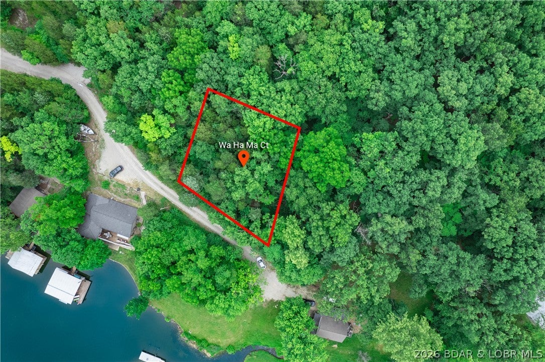 A view like this is the perfect place to start building your Lake of the Ozarks dream! Located in the quiet Wa Ha Ma subdivision, this beautiful residential lot offers impressive lake views and a peaceful setting while keeping you just minutes from the conveniences of Camdenton. Electric is available at the property, and paved road access makes getting to the lot easy. With lake privileges and the water just beyond your doorstep, this is an opportunity to create a full-time home, weekend retreat, or personal lake getaway in an established lake community. Enjoy the best of both worlds—quiet lake-area living without giving up quick access to town. Bring your plans and take advantage of a gorgeous setting with views you'll never get tired of!