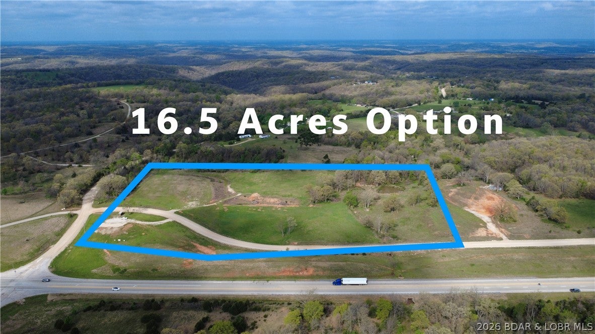 Developers and investors—this approximately 16.57-acre tract offers an exceptional opportunity for a residential housing development just three minutes south of Camdenton. The property represents the larger portion of the 20.57-acre parcel (also available) following the proposed division of approximately four acres from the north end and is subject to survey. Gentle terrain supports efficient planning and construction, while its location outside city limits and lack of HOA restrictions provide flexibility for residential, commercial or mixed-use development. Potential uses include a residential neighborhood, contractor shops, rental units, equipment sales, distribution facilities and other business ventures. Public water is located across Dry Hollow Road, electricity is available nearby and an onsite pond adds utility and character. Convenient access to State Highway 5, Dry Hollow Rd, and Crater Hill Rd provides strong connectivity to Highway 54 and I-44. Call or text for additional information!