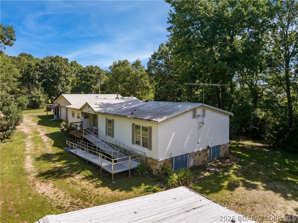 Country Ranch Home with 15 Acres on the River.  There is a walk-in Cave down by the River with a great place to put in your Kayaks or Canoes.  The Home has a Handicapped Ramp that leads to a covered Entry.  There is open Living/Dining Rooms, Wood Fireplace, Laminate Flooring and doors to the Covered & Screened Deck in the back.  The Kitchen has a Work Island, Pantry and lots of Cabinets.  There are 2 Stoves.  One is electric and one is gas that is used for canning.   The Master Bedroom/Bath has double Sinks, Jetted Tub, Walk-In Closet and French Doors to the large back Covered Deck.  There is an extra attached Living Area with Kitchen/Dining, 2 Bedrooms, Bath with a Walk-In Shower and a Wood Stove.   The 2-Car attached Garage has a built-on Carport.  The Storage Shed also has electric hookup for a Camper or RV.  The Fenced Area in the Yard has a Chicken House and room for Goats.  There is also a large Garden area.  This private Home is a perfect location with the Cave and nice River frontage. It is close to the Mother Nature Conservatory Campground and the River Bend Campground.