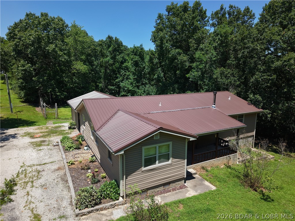 31+ ACRE PRIVATE RECREATIONAL RETREAT IN GRAVOIS MILLS

Tucked just off P Road, this 31.78-acre property offers the rare combination of total privacy, prime hunting, and fast access to Lake of the Ozarks. It is ideal for a full-time residence, homestead, or weekend getaway.

The land features 31.78 mostly fenced acres with established ATV trails, a wet-weather creek, a fenced garden space, and a turn-key setup with deer stands for abundant native wildlife. Outdoor living spaces include a covered front porch and a huge back deck ready for entertaining, a hot tub, or a future pool setup. For storage, you have an attached 2-car garage plus a large storage shed for equipment and gear.

Inside, the 2,247 square foot home offers 3 bedrooms, 2 full baths, and a spacious primary suite equipped with a walk-in shower and walk-in tub. You can buy with confidence knowing a new roof and siding were installed within the last 2 to 3 years. Unplug on your own private acreage, ride the trails, or head to the lake in minutes. Schedule your private tour today.