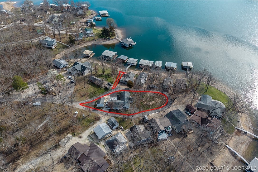 Seller has transformed this older home into a very comfortable full time home with lots of creative and thoughtful ideas. Sitting in the tear drop of the subdivision who have blacktop and lakeview for 360 degree. The level lawn is great for outdoor activities. Your private covered dock is just steps for your front door and no stairs to the dock, The open floor plan features one level living, 2 living areas an office, finished sq. ft. in the attic and master suite with huge walk-in shower and huge walk in closet with lots of built-ins. Great location by road and water.