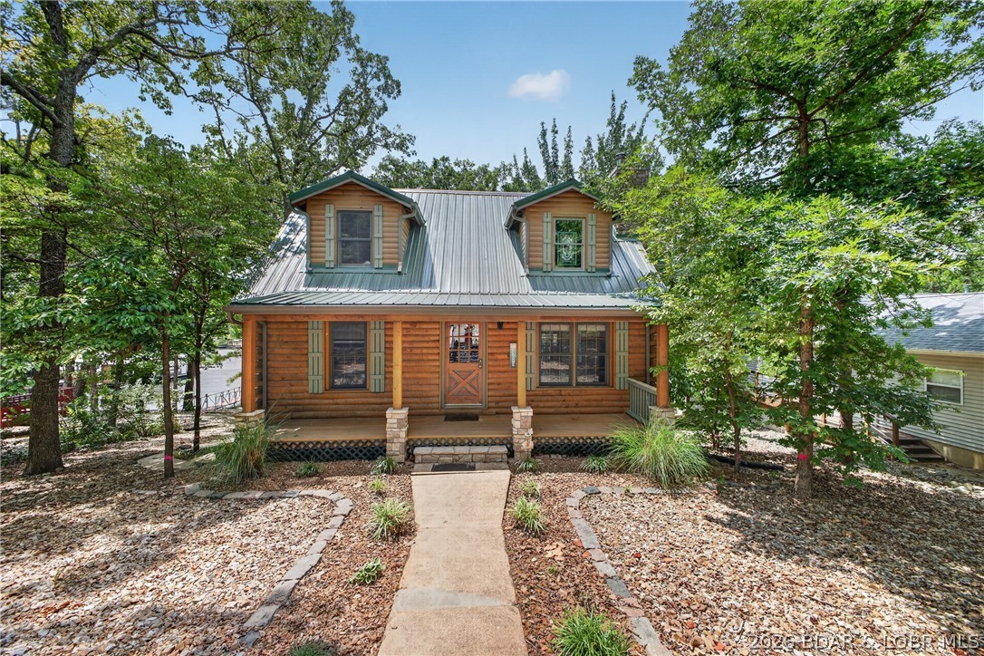 Tucked into one of the most convenient locations at Lake of the Ozarks, this private waterfront cabin delivers something that’s getting harder to find… easy lake living without the chaos.

No long winding roads. Easy access from town. Easy access by water. Easy to load up and enjoy for the weekend or stay all season long. Located near The Cave Bar & Grill and Nauti Fish Rum Bar, you’re close to the action while still having the privacy and feel of a true lake retreat.

Inside, the home offers 1,944 square feet with main level living, vaulted wood ceilings, natural light, and lake views throughout. Outside features include 75’ of waterfront, gentle lot, a 2-slip concrete dock with swim platform, screened porch, detached garage, and multiple spaces built for gathering and relaxing.

The home has the authentic lake cabin feel people want, with the opportunity to make updates over time without stepping into an overwhelming project or price point.

Whether you’re looking for a weekend escape, full-time lake living, or a short-term rental investment opportunity, this property checks boxes that are getting tougher to find at the Lake.